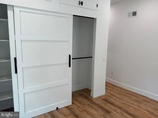 a bathroom with a granite countertop toilet a sink and a mirror