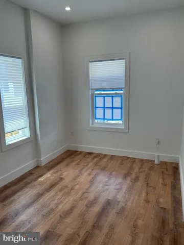 a view of hallway with wooden floor