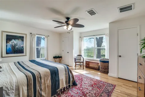a bedroom with a large bed and a chandelier