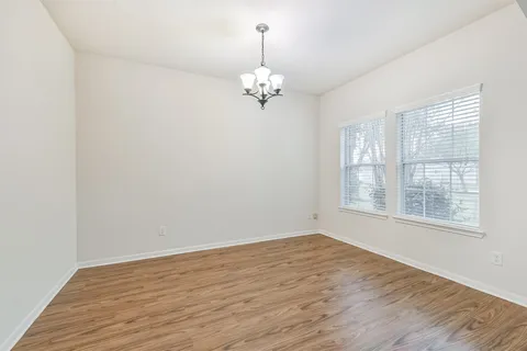 a view of a backyard with a garden and deck