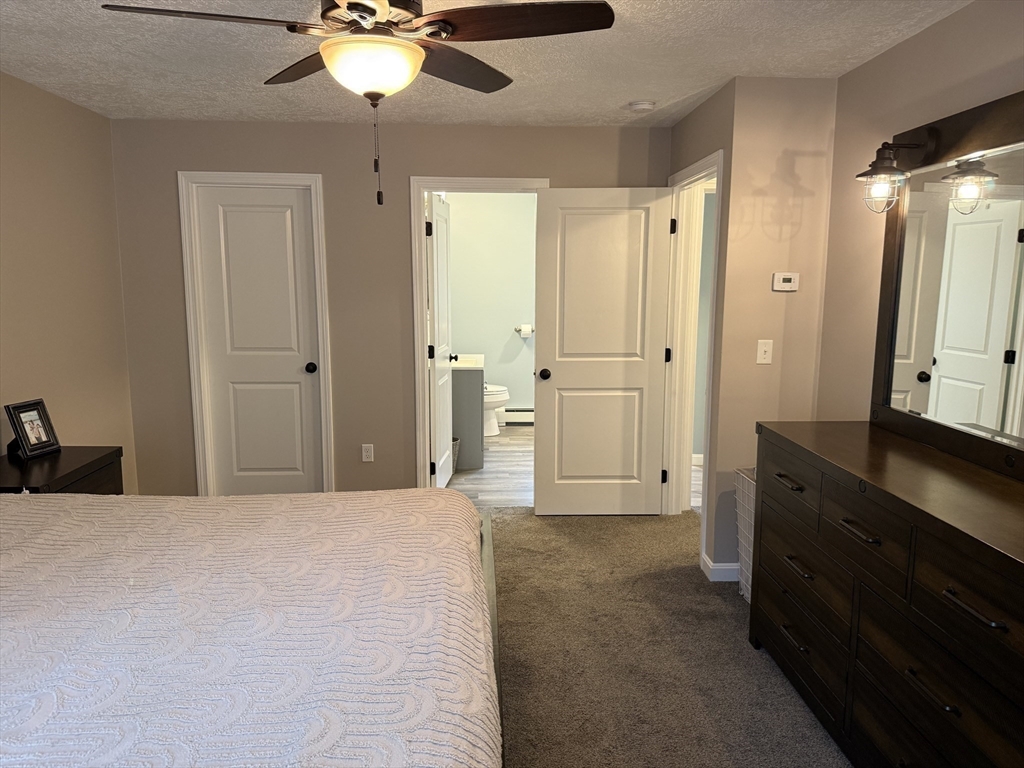 288 Chase Road Athol, MA 01331 - Photo 13 of 24 a large bedroom with a dresser and chandelier