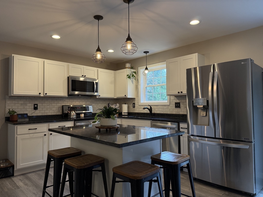 288 Chase Road Athol, MA 01331 - Photo 3 of 24 a kitchen with refrigerator a sink and chairs