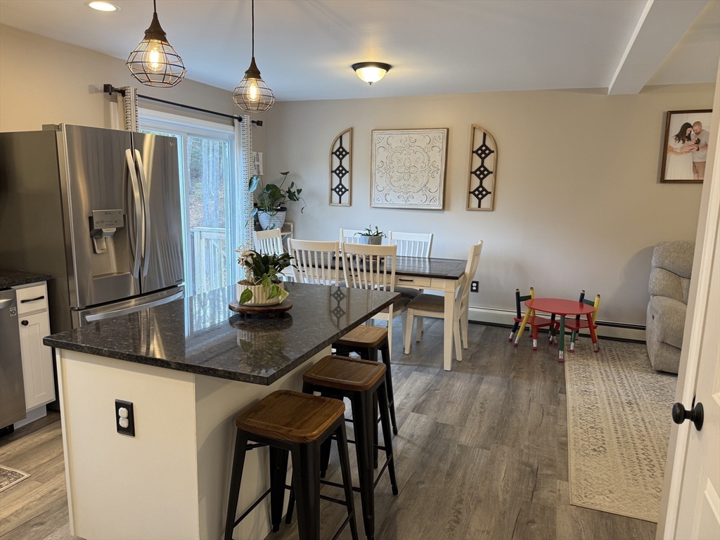 288 Chase Road Athol, MA 01331 - Photo 4 of 24 a kitchen with stainless steel appliances granite countertop a dining table chairs refrigerator and sink