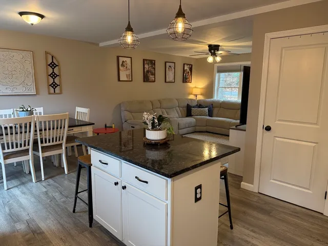 a kitchen with a table chairs and cabinets