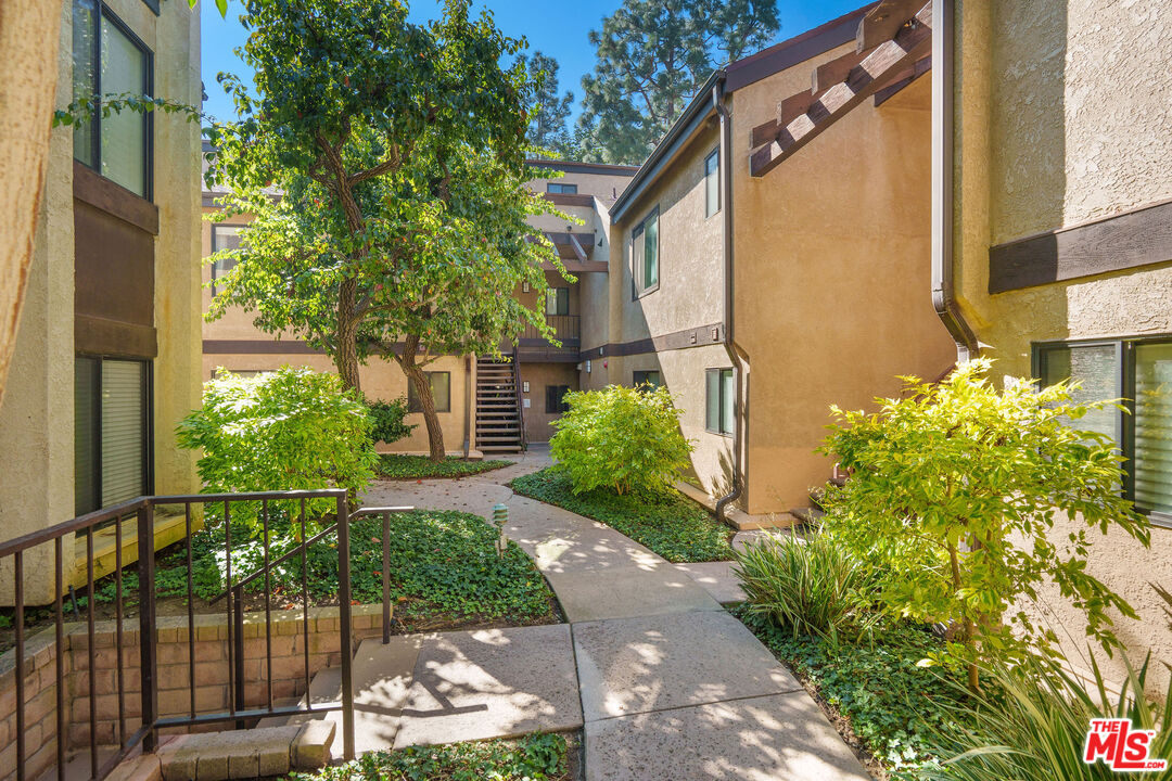 8114 Manitoba Street, Unit 208 Playa del Rey, CA 90293 - Photo 19 of 27 a front view of a house with a yard