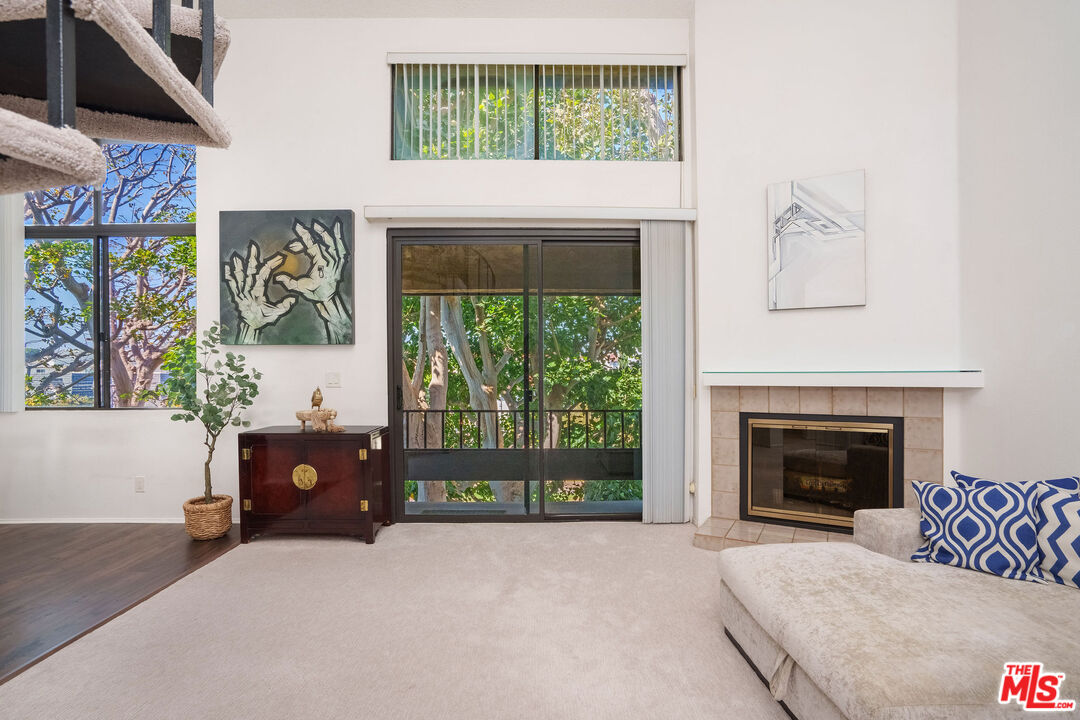 8114 Manitoba Street, Unit 208 Playa del Rey, CA 90293 - Photo 2 of 27 a living room with furniture and a fireplace