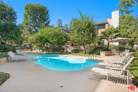 a view of a swimming pool with lounge chair