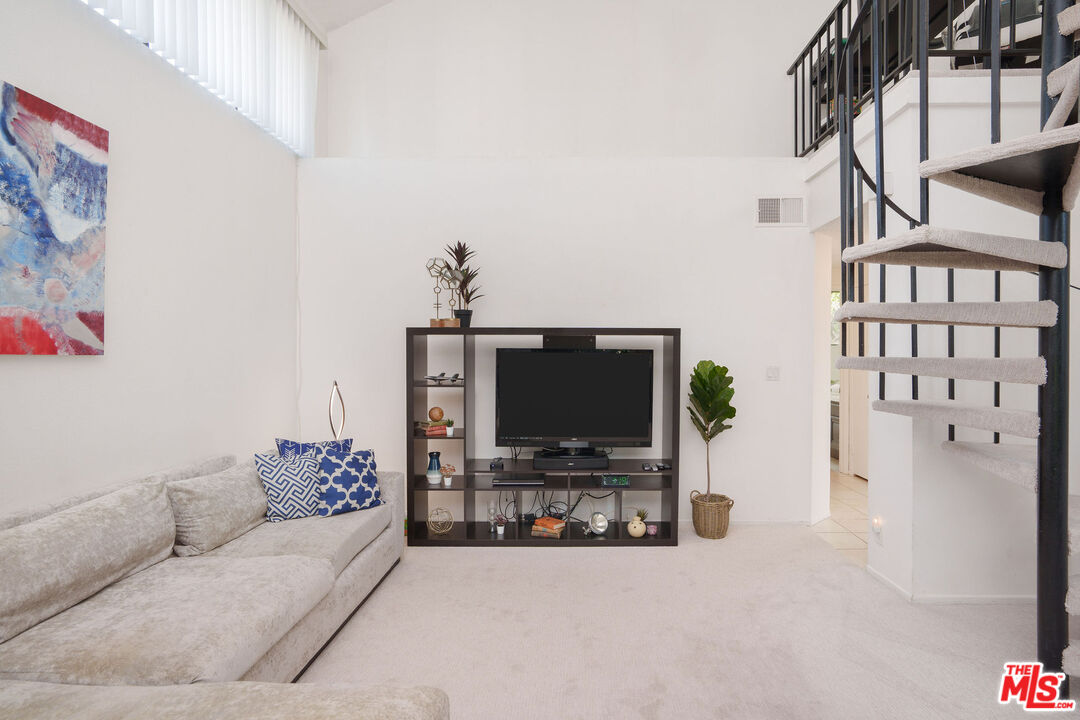 8114 Manitoba Street, Unit 208 Playa del Rey, CA 90293 - Photo 4 of 27 a living room with furniture and a flat screen tv