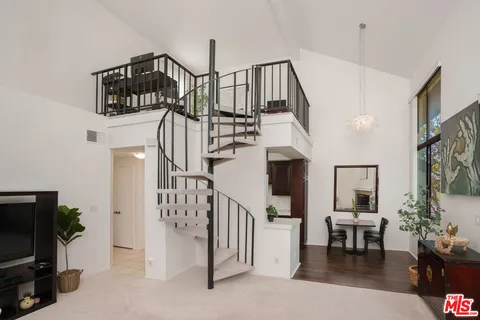 a view of entryway livingroom and hall with wooden floor