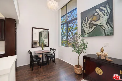 a view of a workspace with furniture and wooden floor