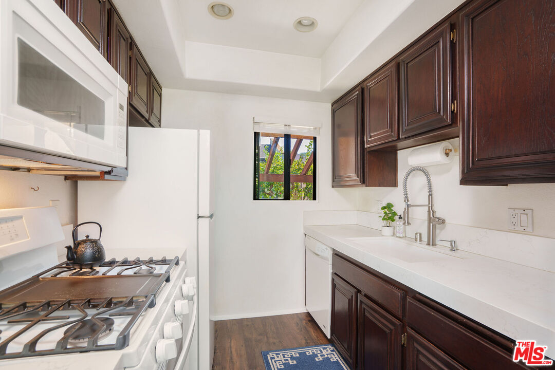 8114 Manitoba Street, Unit 208 Playa del Rey, CA 90293 - Photo 7 of 27 a kitchen with sink a stove and cabinets