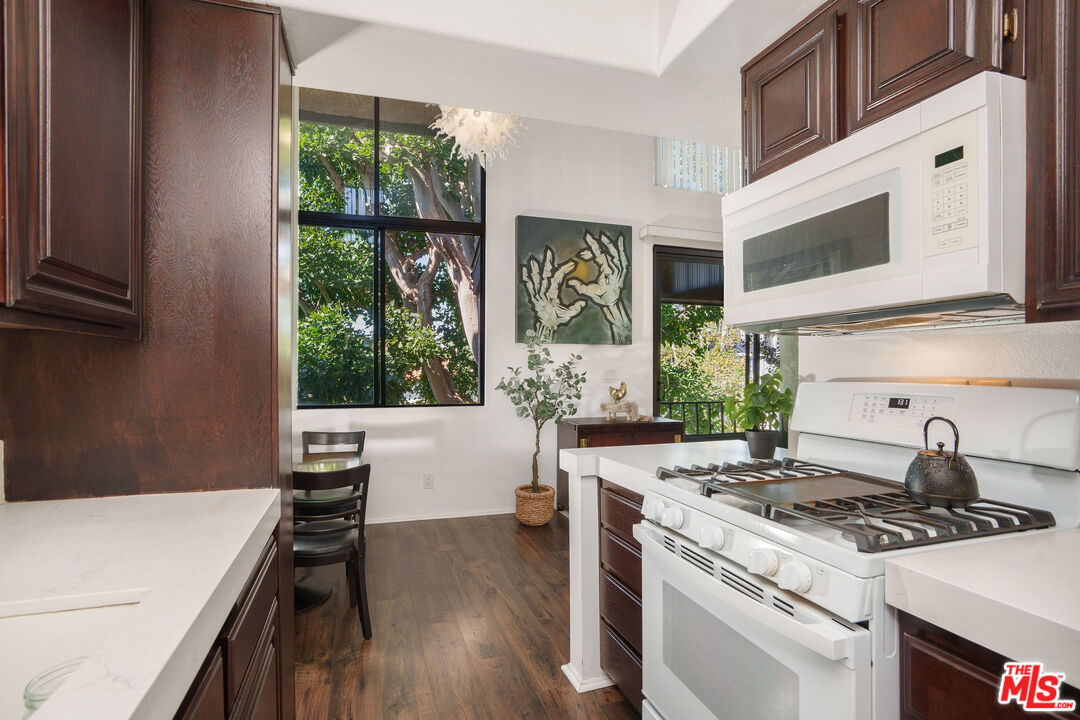 8114 Manitoba Street, Unit 208 Playa del Rey, CA 90293 - Photo 9 of 27 a kitchen with a stove and a wooden floor
