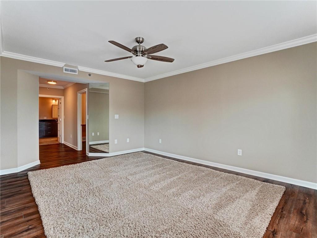 3435 Kingsboro Road Northeast, Unit 1601 Atlanta, GA 30326 - Photo 24 of 54 a view of a big room with wooden floor and windows