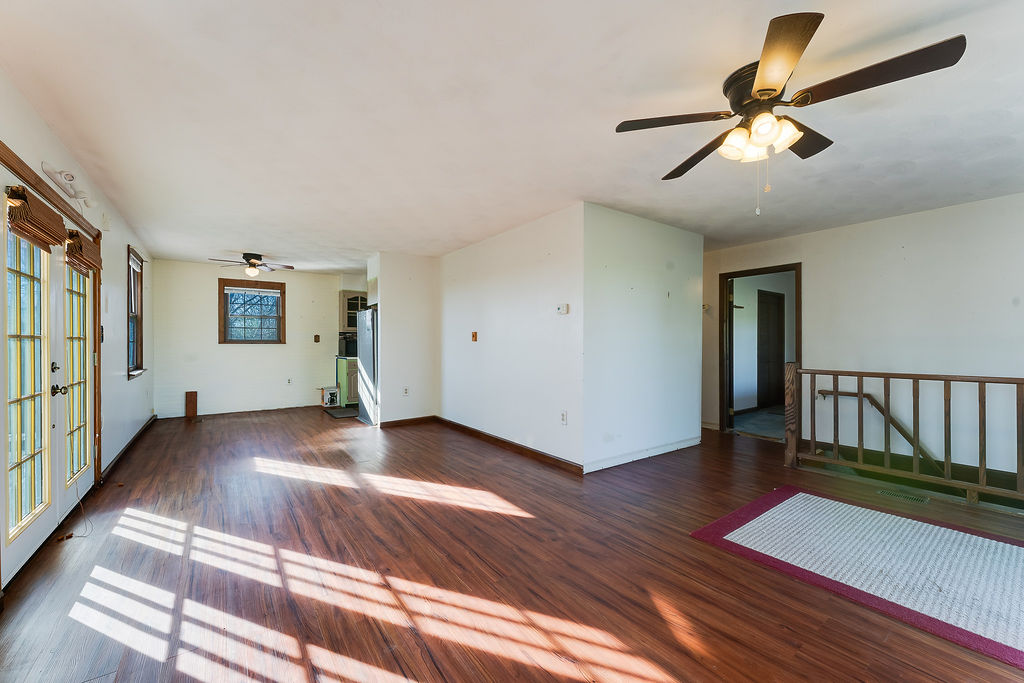 100 Nichols Ridge Road Seaman, OH 45679 - Photo 15 of 43 This bright living space features rich hardwood flooring and French doors, offering versatile design possibilities.