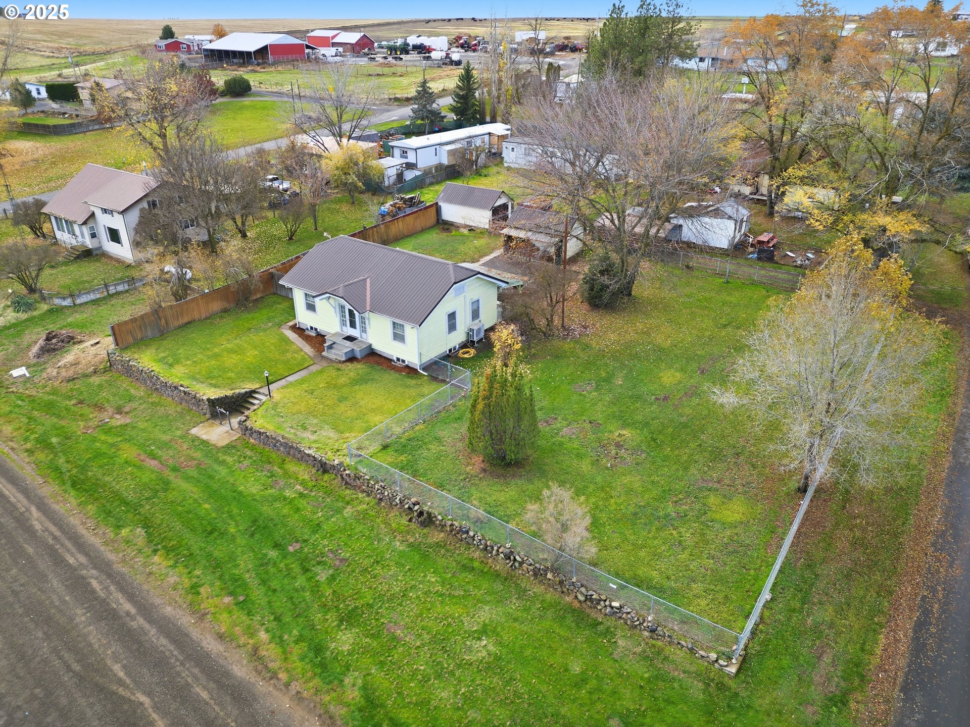 an aerial view of a house with a garden and lake view