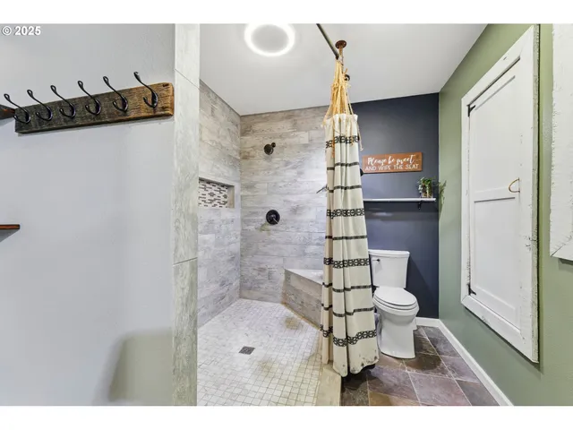 a bathroom with a toilet a sink and shower