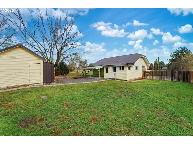 a view of an house with backyard space and garden