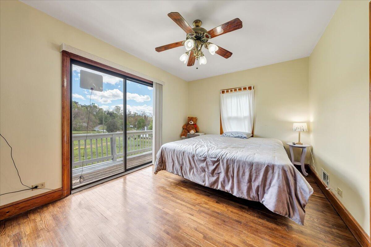 5265 Blue Ridge Boulevard Blue Ridge, VA 24064 - Photo 15 of 40 a bedroom with a large bed and a large window