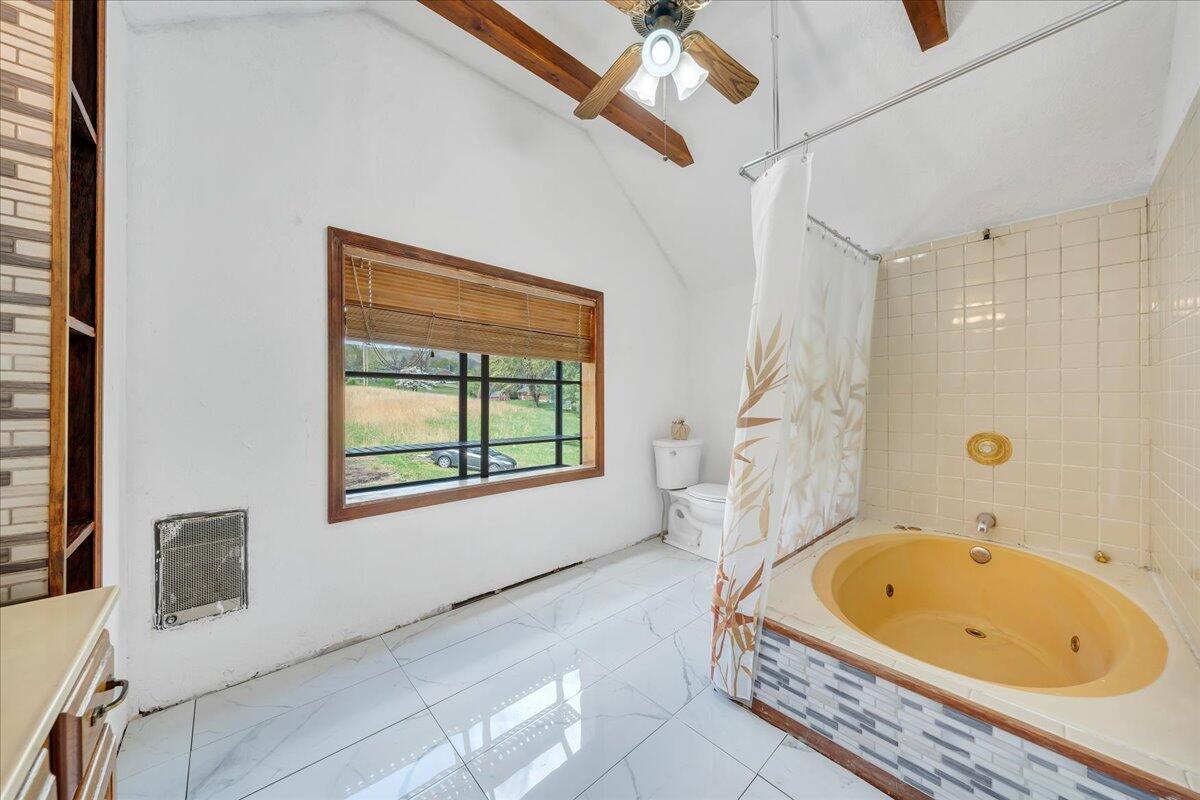 5265 Blue Ridge Boulevard Blue Ridge, VA 24064 - Photo 19 of 40 a bathroom with a tub and a window