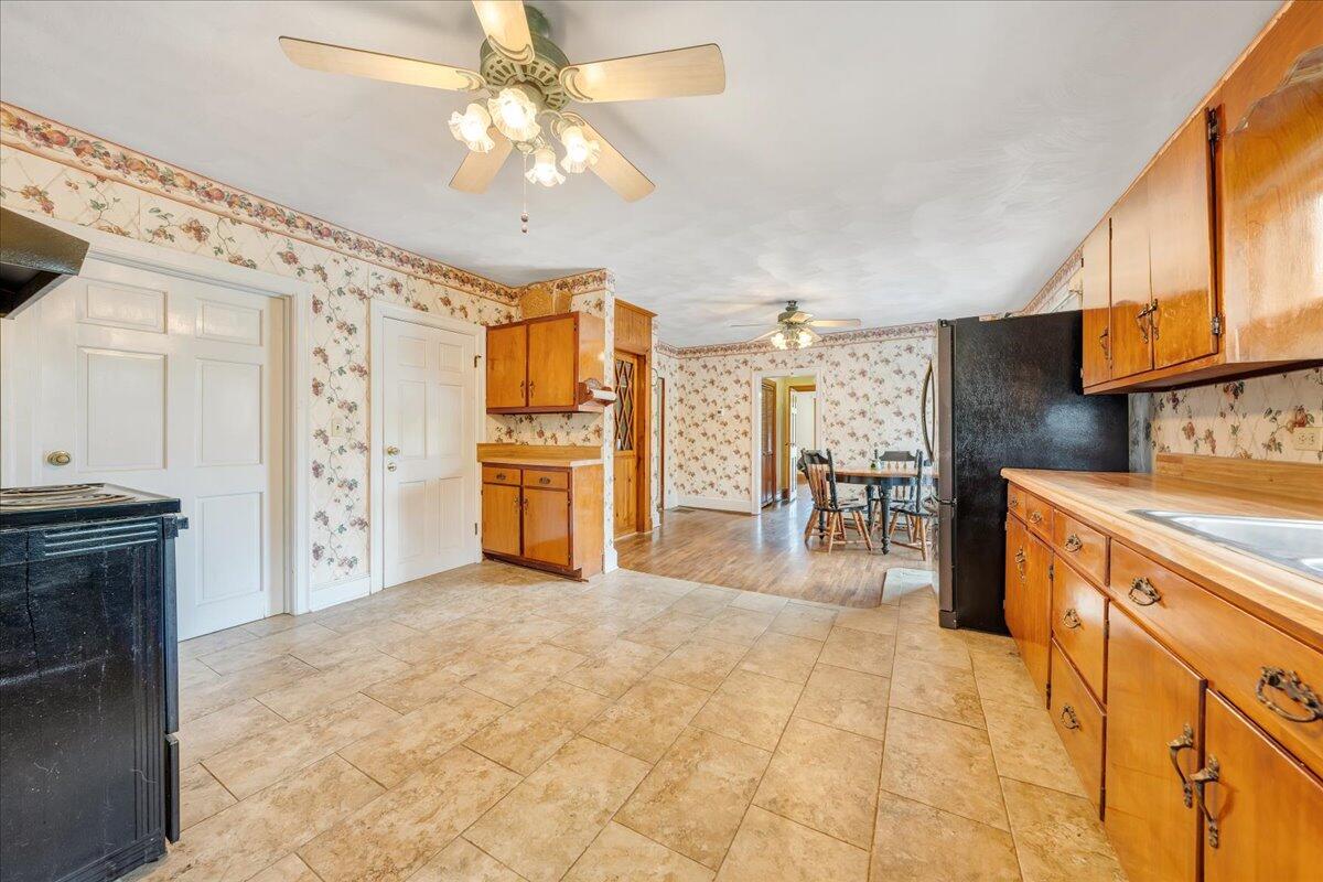 5265 Blue Ridge Boulevard Blue Ridge, VA 24064 - Photo 6 of 40 a kitchen with stainless steel appliances kitchen island granite countertop a refrigerator and a stove top oven