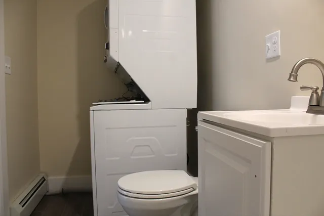 a bathroom with a toilet a sink and a mirror