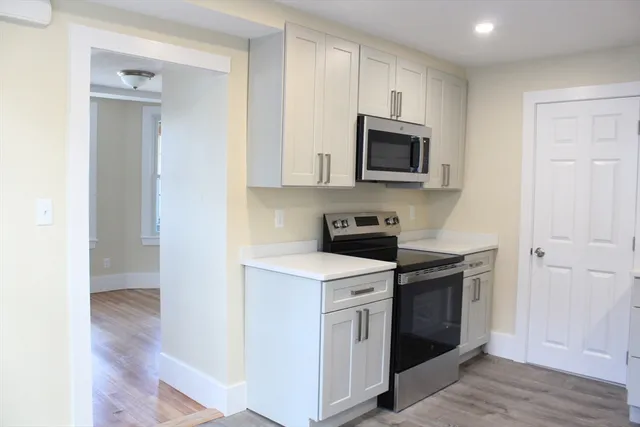 a kitchen with stainless steel appliances granite countertop a stove and a microwave
