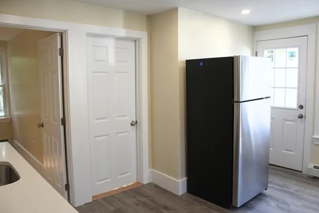 a view of a kitchen with a refrigerator and a sink