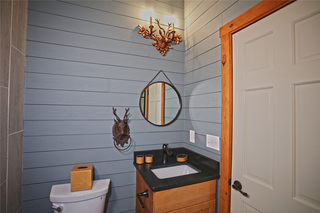 275 Jocassee Lake Road Salem, SC 29676 - Photo 13 of 41 This cozy bathroom features shiplap walls, a vanity, and stylish fixtures.