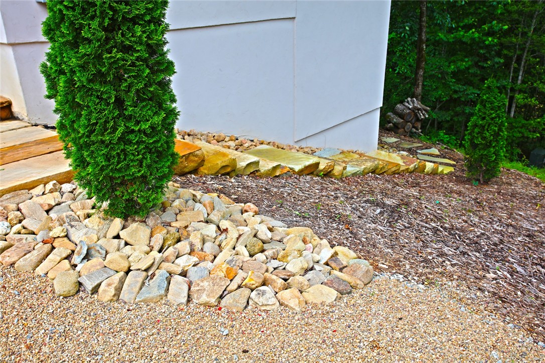 275 Jocassee Lake Road Salem, SC 29676 - Photo 3 of 41 This serene landscape features natural rock accents, creating a harmonious and tranquil outdoor retreat.