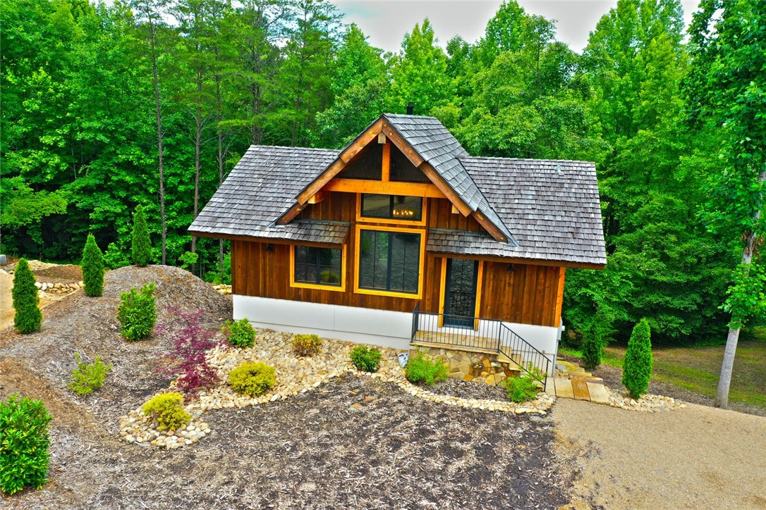 275 Jocassee Lake Road Salem, SC 29676 - Photo 33 of 41 This charming home features a wooden exterior and a shingle roof, nestled among lush trees.