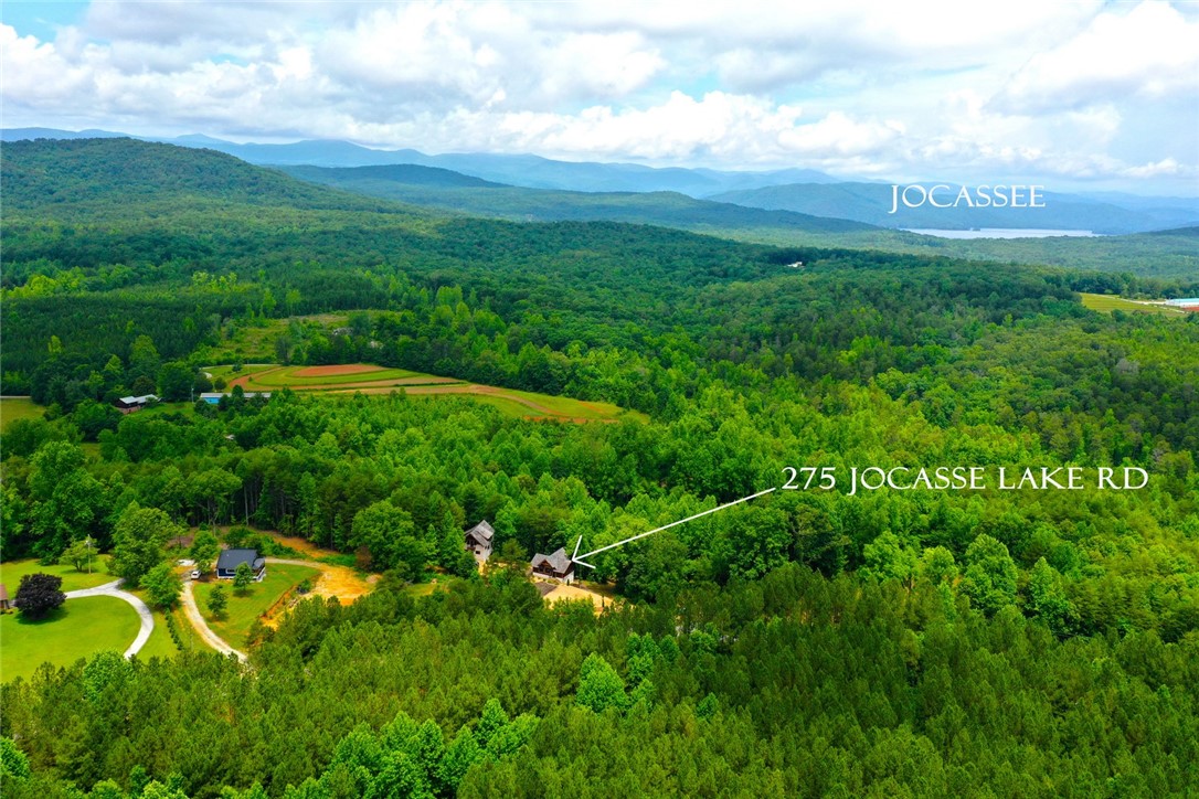 275 Jocassee Lake Road Salem, SC 29676 - Photo 35 of 41 This aerial view showcases a verdant landscape with mountain and lake vistas.