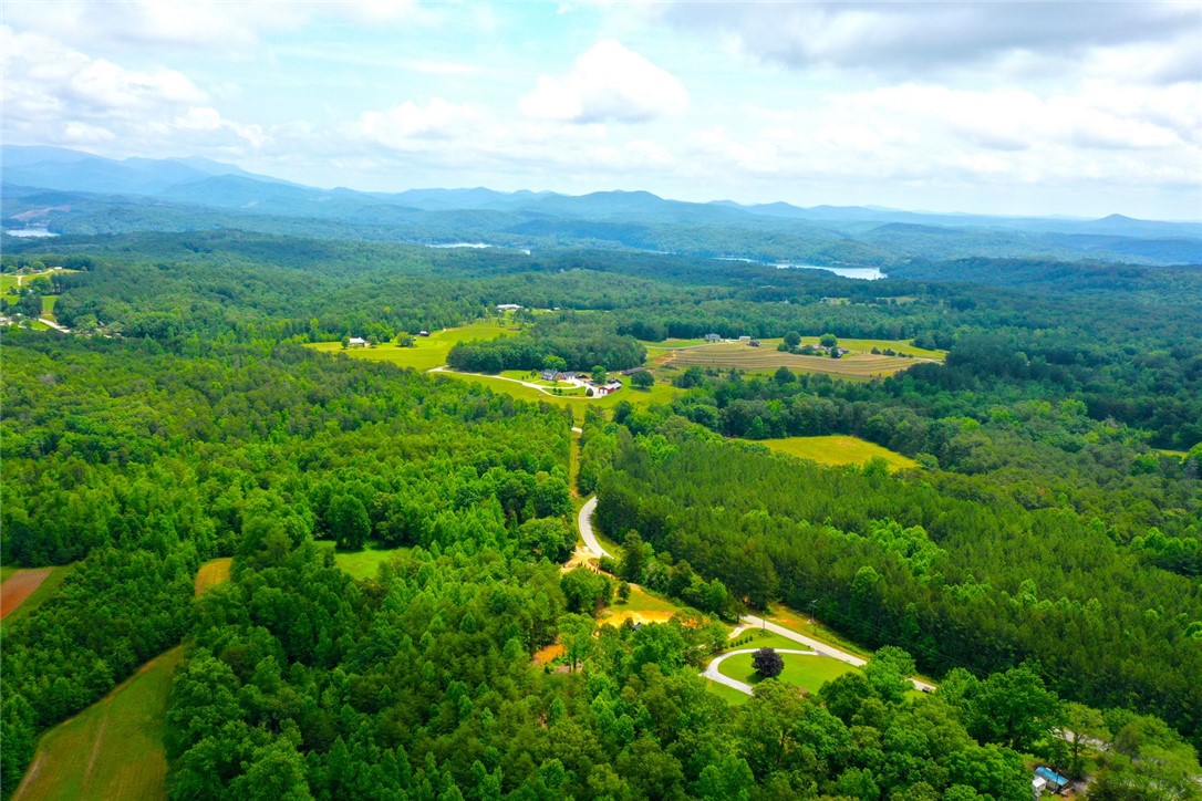 275 Jocassee Lake Road Salem, SC 29676 - Photo 36 of 41 This elevated view captures a serene landscape of rolling hills, lush woodlands, and distant bodies of water.