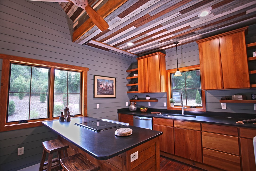 275 Jocassee Lake Road Salem, SC 29676 - Photo 8 of 41 This kitchen features a dynamic wood-paneled ceiling and expansive windows overlooking lush greenery.