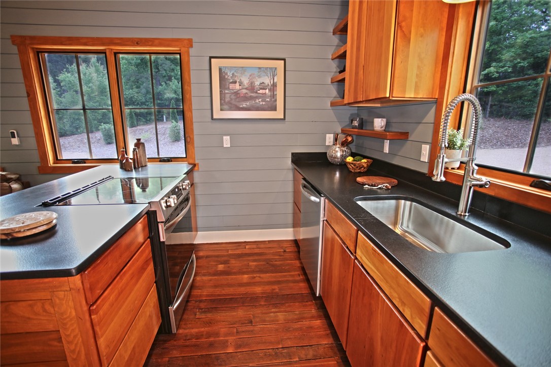 275 Jocassee Lake Road Salem, SC 29676 - Photo 10 of 41 This charming kitchen features rich hardwood flooring and sleek countertops, perfect for culinary adventures.
