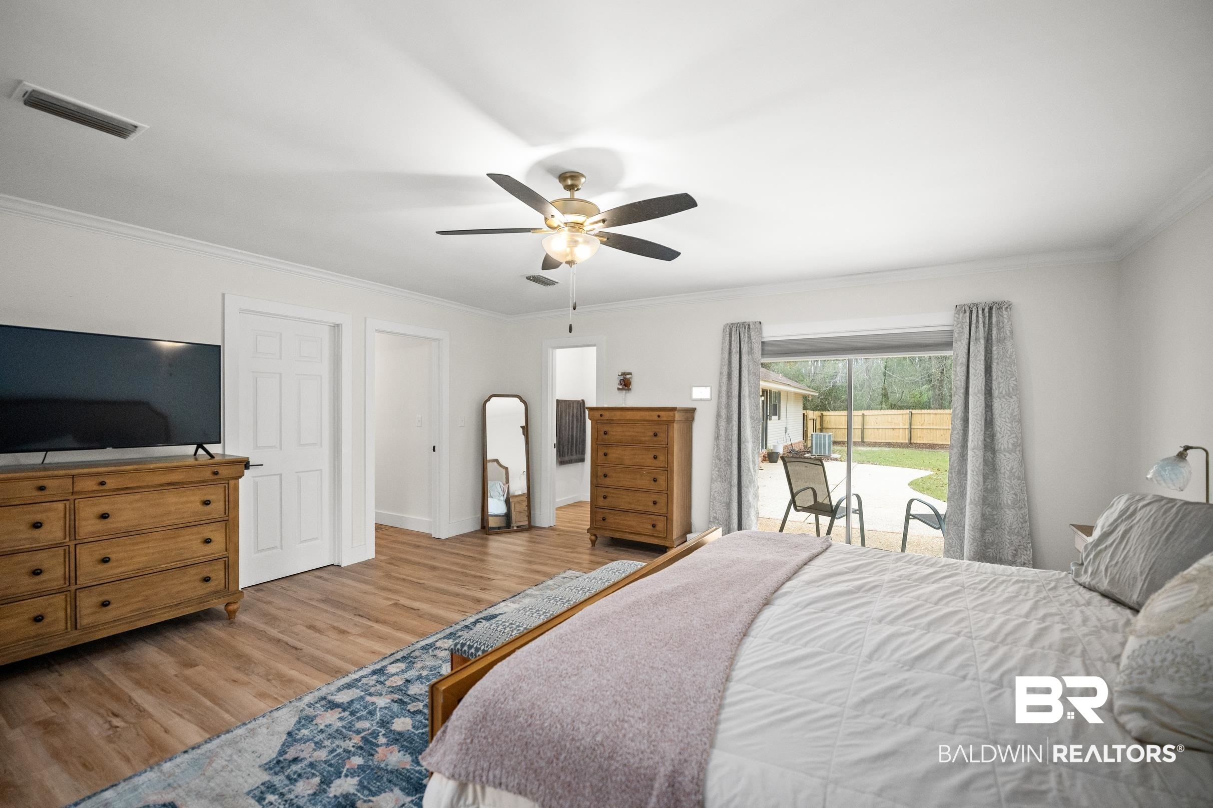 6 Wren Circle Foley, AL 36535 - Photo 41 of 55 Bedroom with a ceiling fan, wood finished floors, visible vents, crown molding, and access to outside