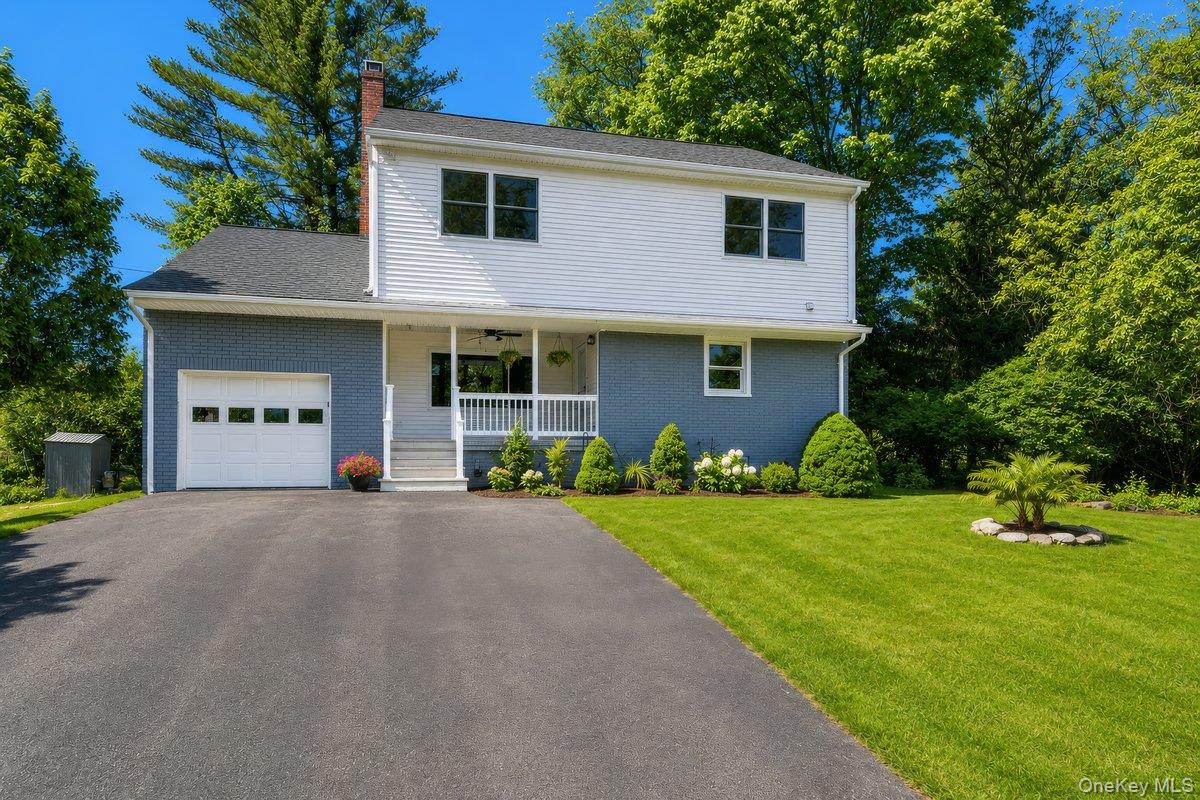 Two-story residence featuring a white siding upper level and a blue brick lower level