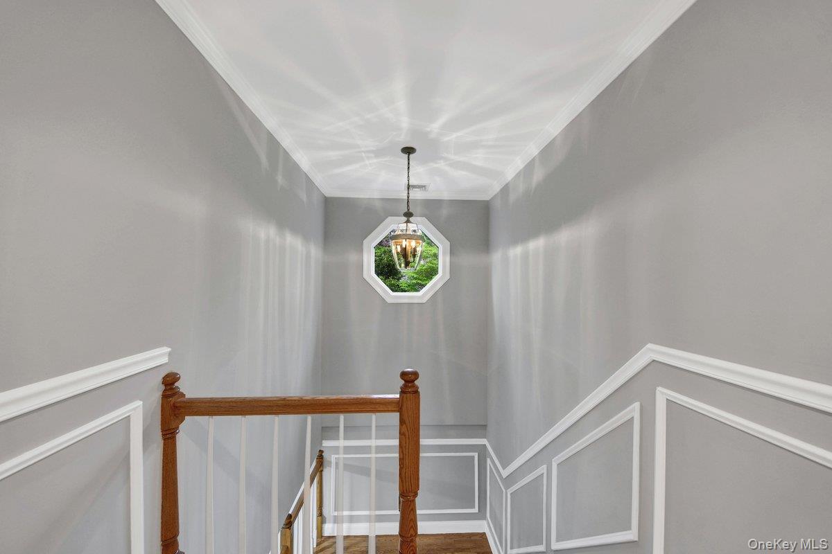 7 Rutledge Road Valhalla, NY 10595 - Photo 19 of 37 Staircase featuring wood-finish handrails, white balusters, and wainscoting details