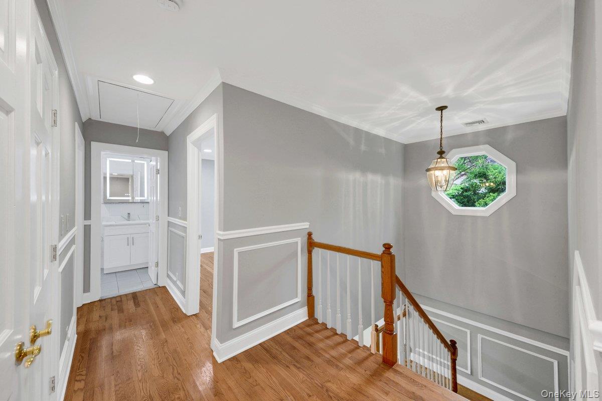 7 Rutledge Road Valhalla, NY 10595 - Photo 20 of 37 Upper-level hallway featuring wood-finish flooring, wainscoting, and crown molding