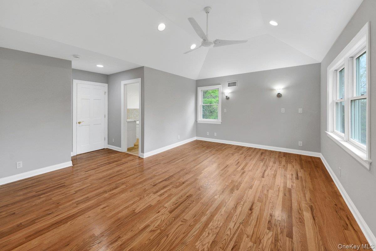 7 Rutledge Road Valhalla, NY 10595 - Photo 25 of 37 Spacious room featuring vaulted ceilings, wood-finish flooring, recessed lighting, a modern ceiling fan, and multiple windows