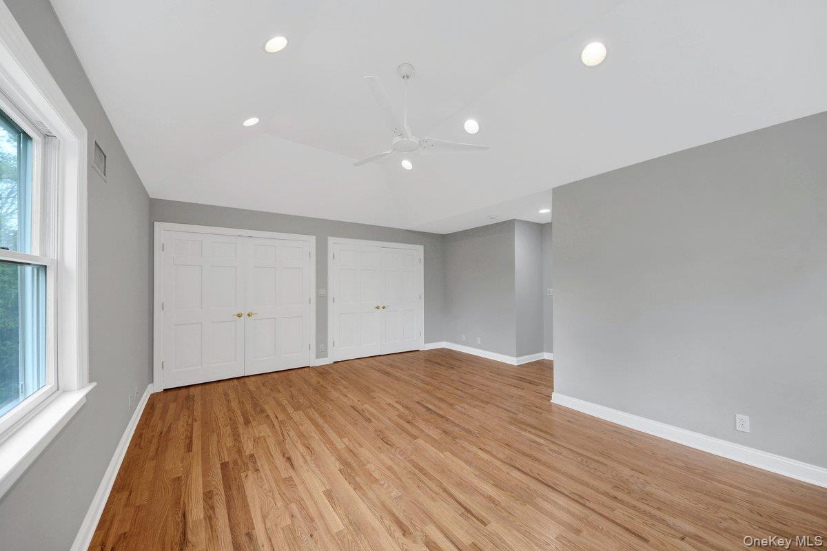 7 Rutledge Road Valhalla, NY 10595 - Photo 27 of 37 Spacious room featuring wood-finish flooring, two sets of double-door closets, recessed lighting, a ceiling fan, and a large window