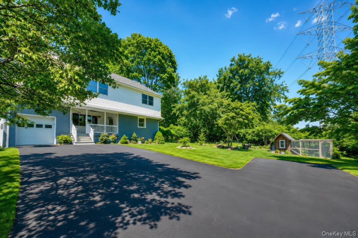 7 Rutledge Road Valhalla, NY 10595 - Photo 3 of 37 Expansive asphalt driveway leading to a two-story residence with a white and blue exterior