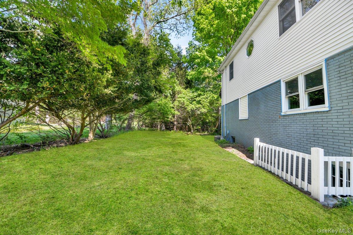 7 Rutledge Road Valhalla, NY 10595 - Photo 33 of 37 Expansive green lawn bordering a two-story exterior with white siding and painted brick