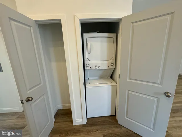 a view of washer and dryer with wooden floor
