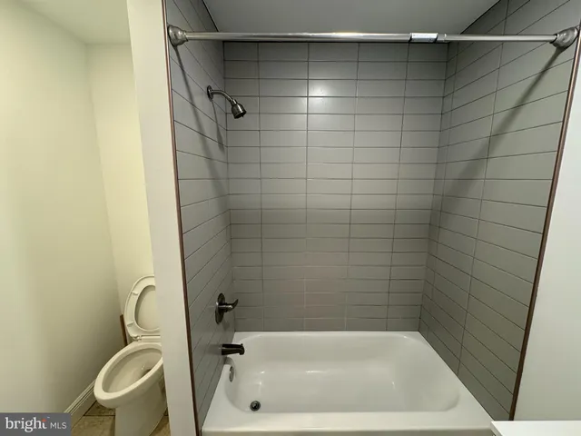 a bathroom with a tub and a shower