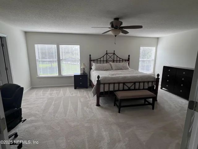 a bedroom with a bed furniture and a window