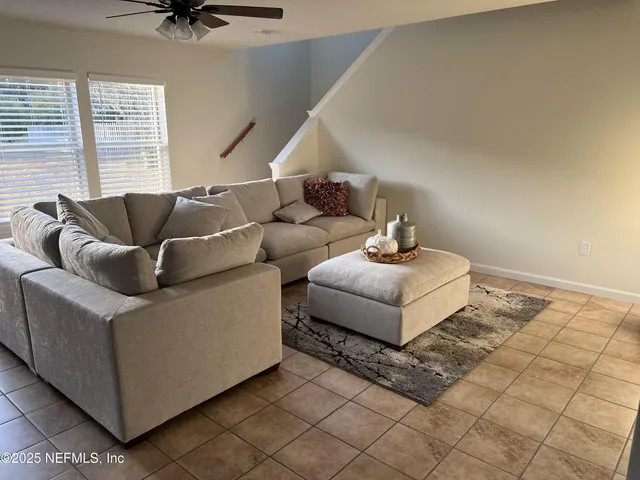 a living room with couches and a flat screen tv
