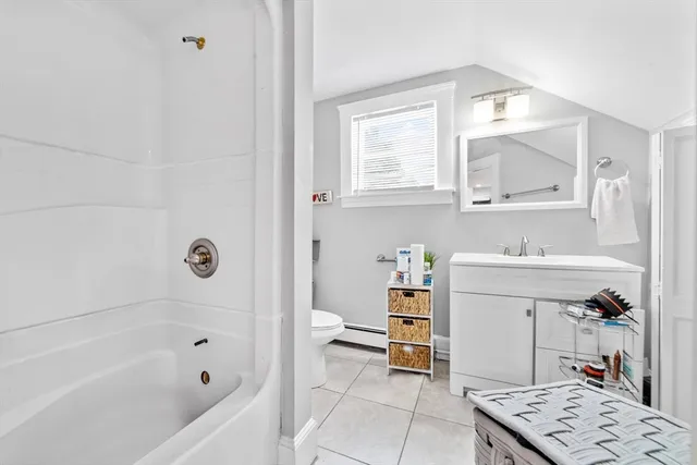 a bathroom with a sink mirror vanity and bathtub