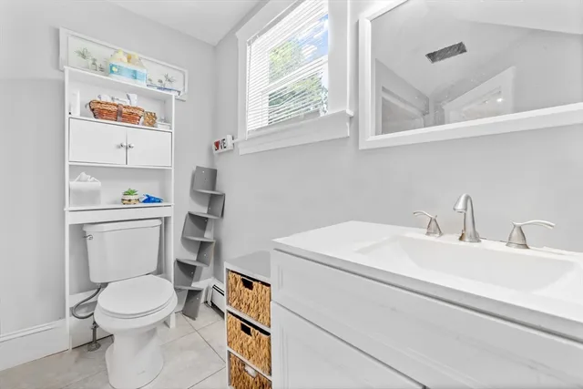 a white toilet sitting next to a bathroom sink