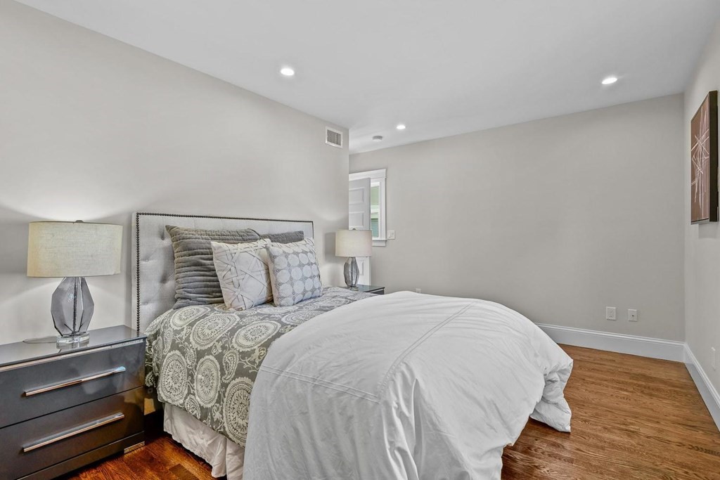 151 Beaver Street, Unit 2 Boston, MA 02136 - Photo 8 of 20 a bedroom with a bed and wooden floor