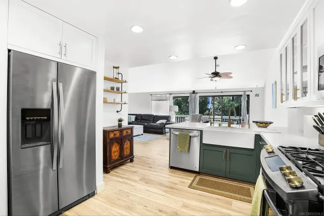 a kitchen with stainless steel appliances granite countertop a refrigerator stove and sink